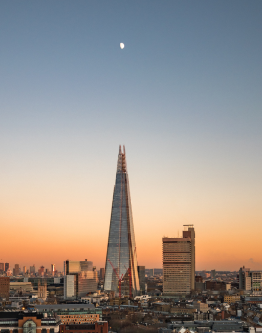 Sunset view of The Shard with the moon directly above it
