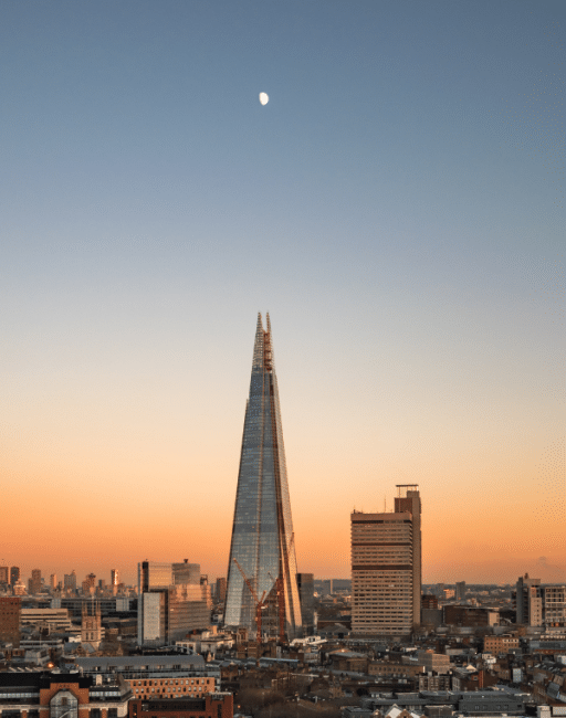 Sunset view of The Shard with the moon directly above it