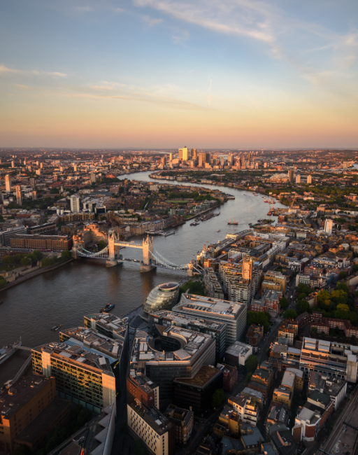 View of London and the River Thames at sunset. Tower Bridge is central to the image